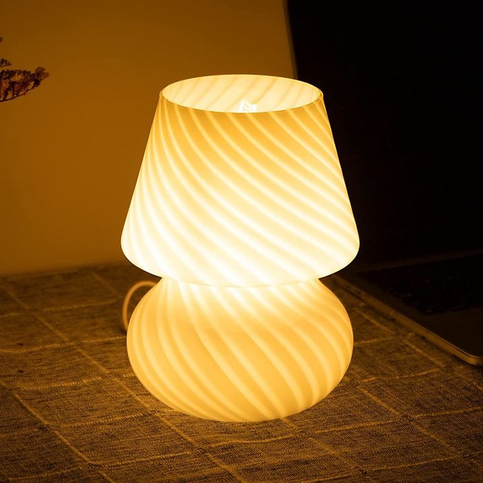 The glass mushroom lamp glowing warmly.