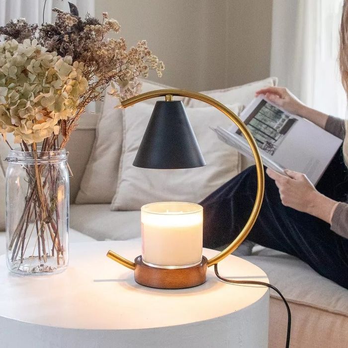 A candle warmer placed on a side table, adding a touch of elegance