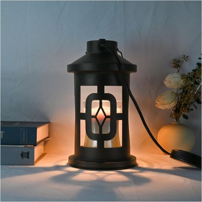 A charming lantern casts a warm glow on a table filled with books and flowers, creating a cozy and inviting atmosphere