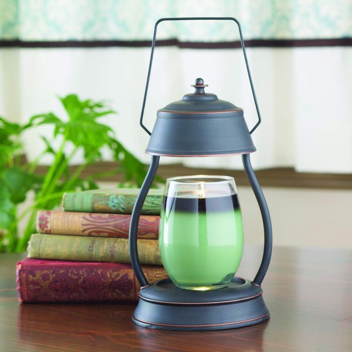 A lantern-style candle warmer placed gracefully on a table, adding a cozy and inviting touch.
