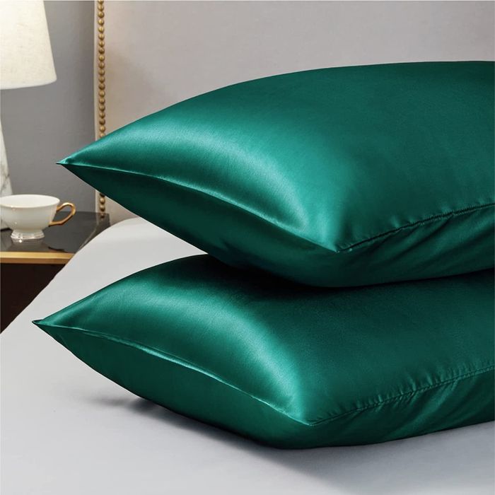 A pair of rich emerald green pillowcases.