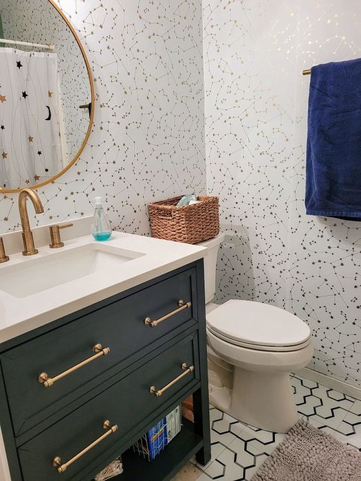 The bathroom walls are adorned with the Novogratz Constellations Removable Peel and Stick Wallpaper in Frost, offering a fresh, modern design.