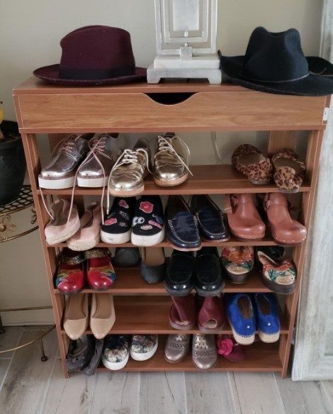 A reviewer shared an image of the wooden shoe rack assembled in their home