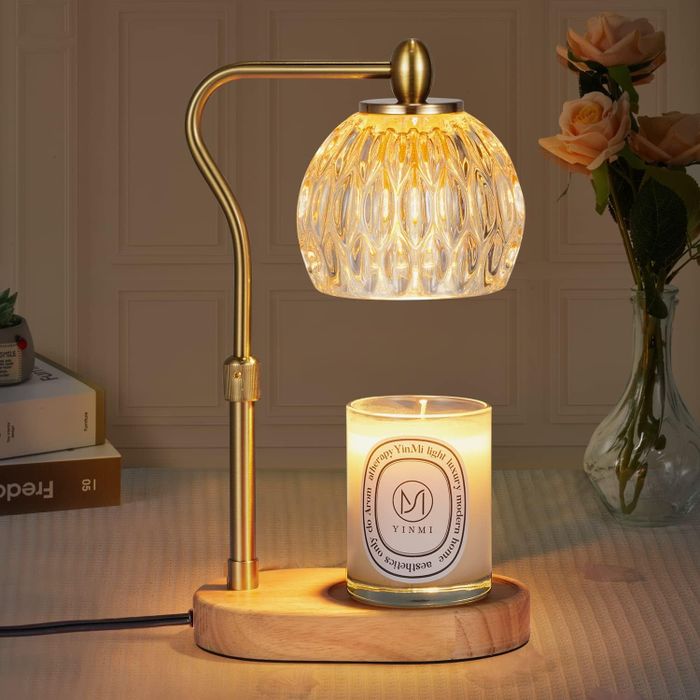 A candle warmer placed on a table with a candle underneath it