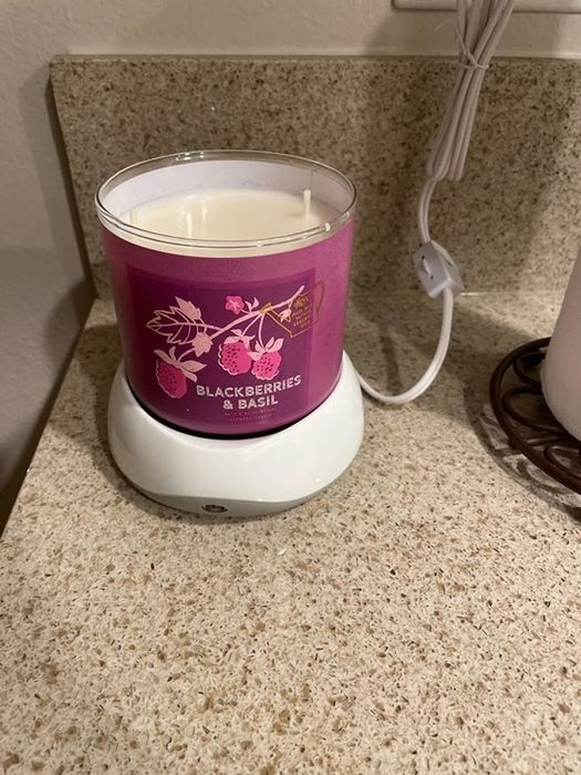 A candle warmer from the reviewer, with a Bath & Body Works candle placed on top, offering a stylish and functional solution for melting wax.
