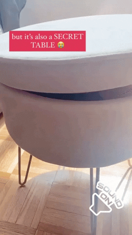 Mytour editor demonstrates by flipping the ottoman's top to reveal both storage space and a tabletop surface beneath it.