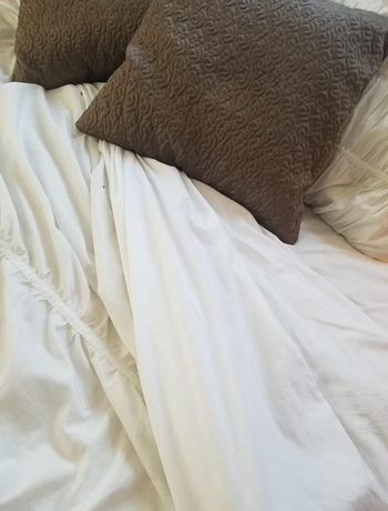A close-up of the white sheets, showcasing their soft texture.