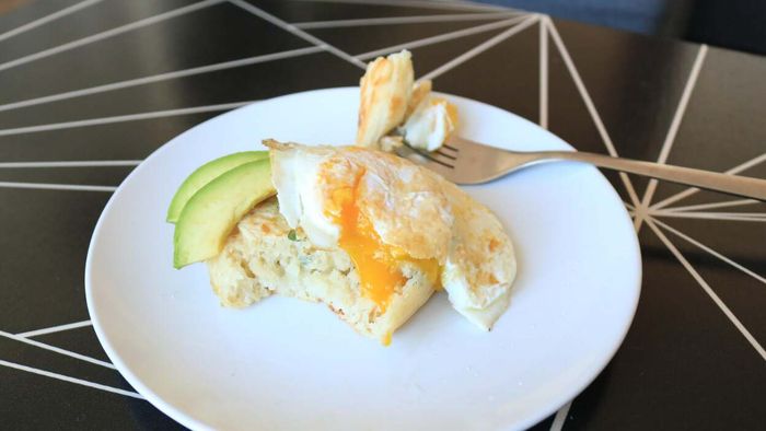 A crumpet topped with egg and avocado.