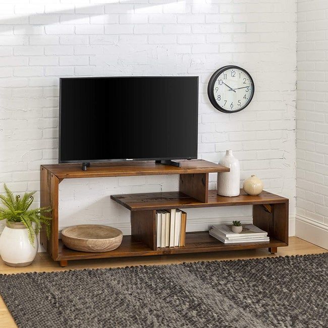An amber-colored TV stand beautifully arranged with books and other decorative items