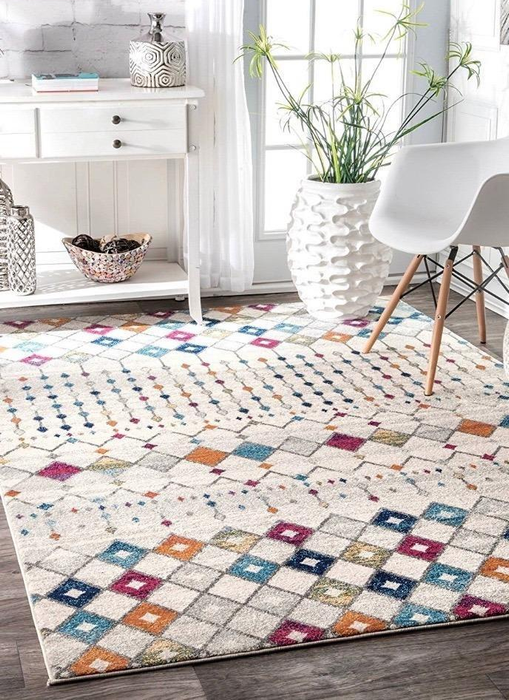 Reviewer photo showing the colorful rug placed near a chair and table