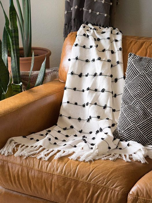the white throw blanket draped over a couch