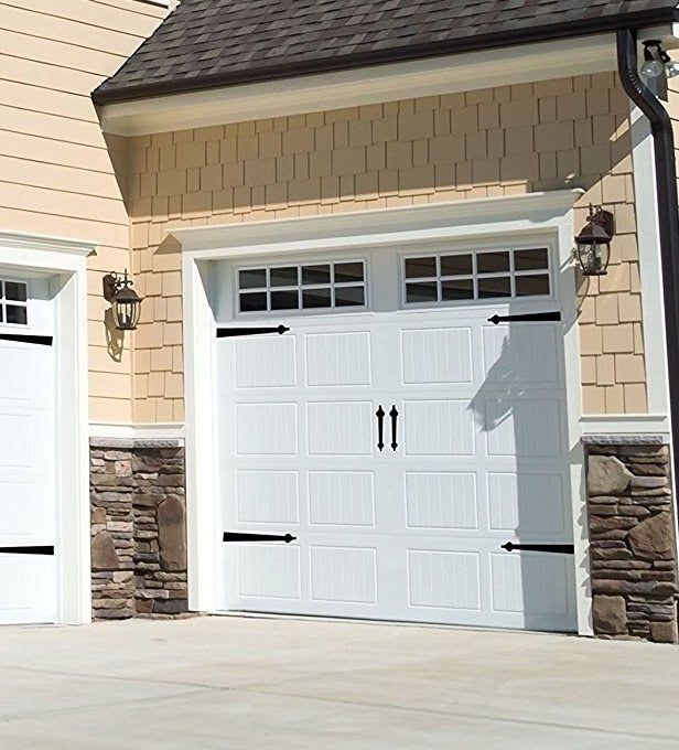 Garage door adorned with magnets at each corner, plus two handles placed in the center.
