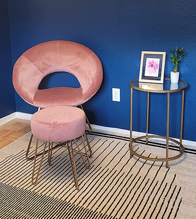 Reviewer photo featuring a pink chair in a room with blue accents