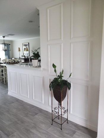 A reviewer's wall, enhanced with white-painted panels to create a sense of depth and dimension.