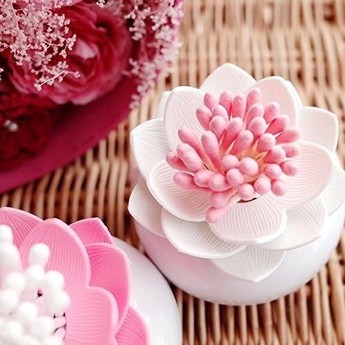 A close-up of a decorative flower ornament featuring pink and white petals, placed on a wicker surface, with a similar ornament in the background.