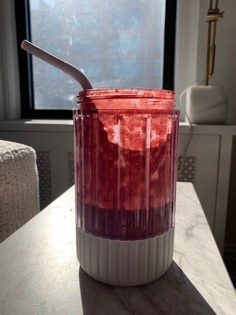 A jar filled with a delicious raspberry-colored smoothie I whipped up