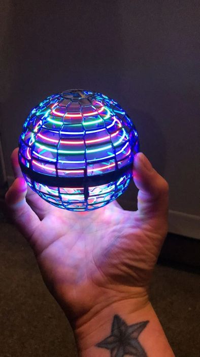 The reviewer is seen holding the glowing ball.