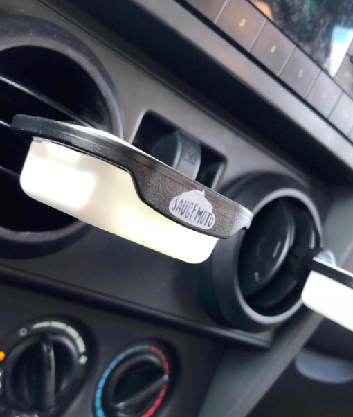 A customer’s review photo featuring the dip clip attached to their car vent.