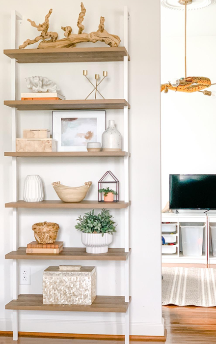 Reviewer image of the white and wood bookshelf displaying decorative pieces