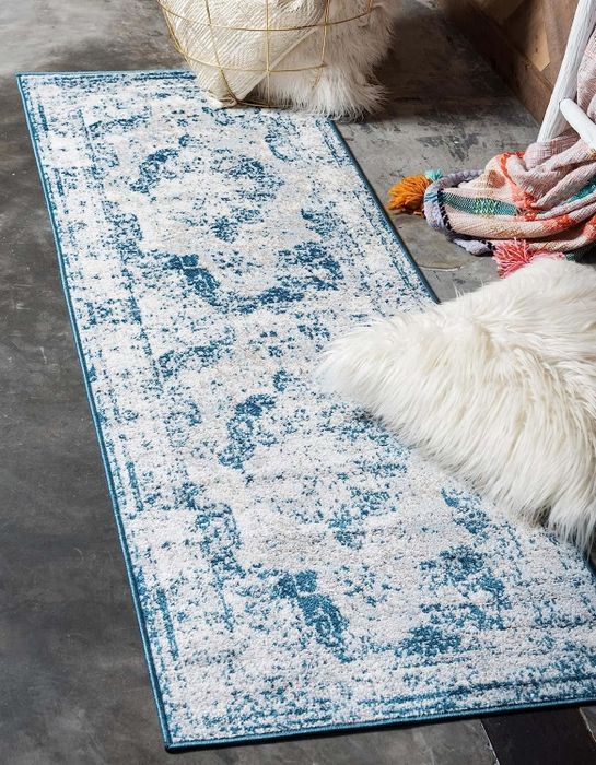 A runner in dark blue, light blue, and light pink with an antique-inspired design.
