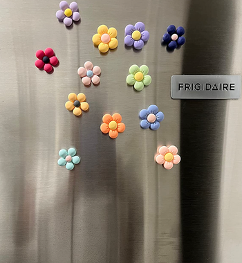 A review image showcasing flower magnets with puffy petals adorning a fridge.