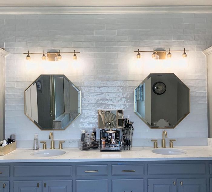 Reviewer photo of two gold mirrors hanging above double sinks in a bathroom.