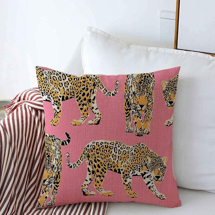 Bright pink pillow cover featuring playful cheetahs.