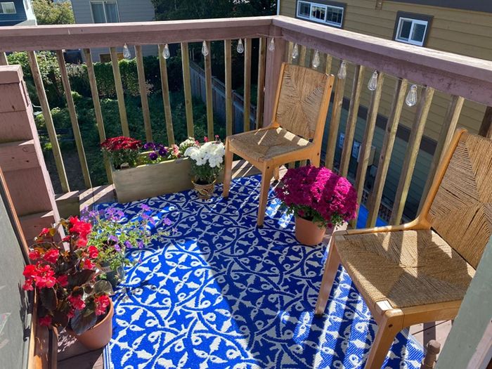 A blue and white patterned rug on the reviewer’s balcony.