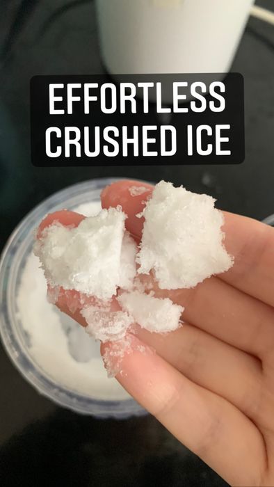 A close-up of my hand holding a few tablespoons of crushed ice
