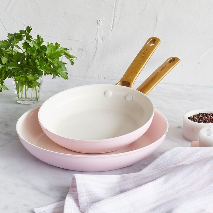 The pink 8-inch and 10-inch frying pans displayed on a kitchen counter