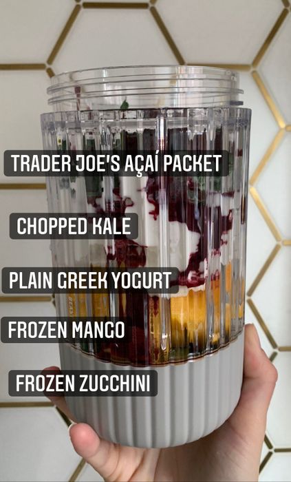 My blending jar filled with the following: frozen zucchini, mango, plain Greek yogurt, chopped kale, and a packet of acai from Trader Joe's