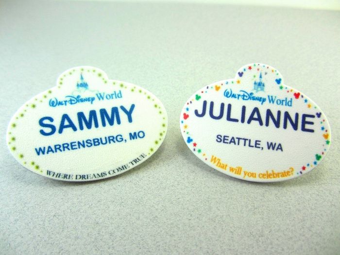 Two personalized Disney World name tags with the names Sammy and Julianne and their locations.