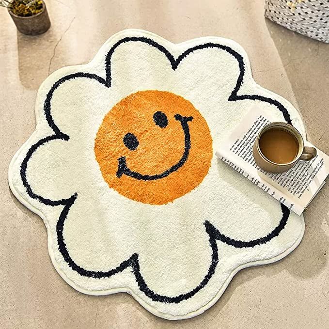A rug featuring a yellow smiley face, outlined by white petals for extra charm.