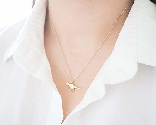 A model showcasing the T-rex necklace in silver.
