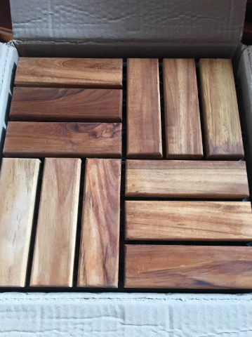 A close-up shot of the elegant teak tiles, showcasing their natural texture and rich color.