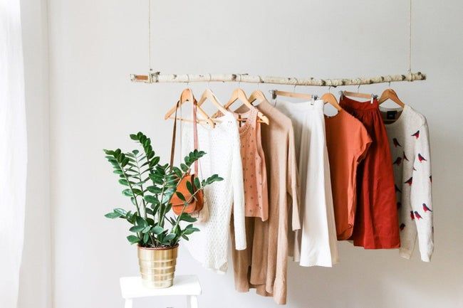 Clothes draped over the birch branch clothing rack