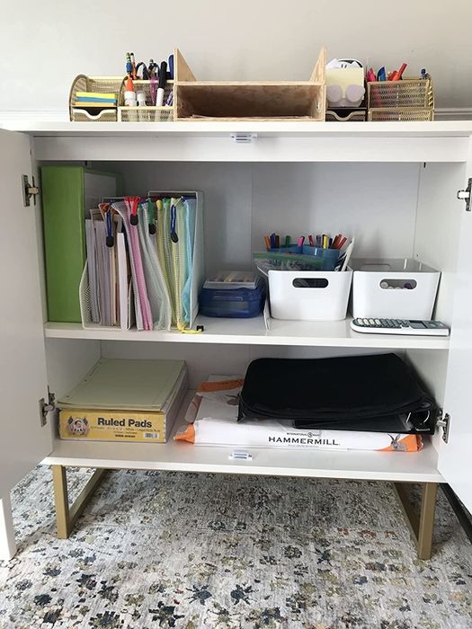 Reviewer photo showing the interior of the accent table with two shelves filled with files, pens, paper, and various office supplies