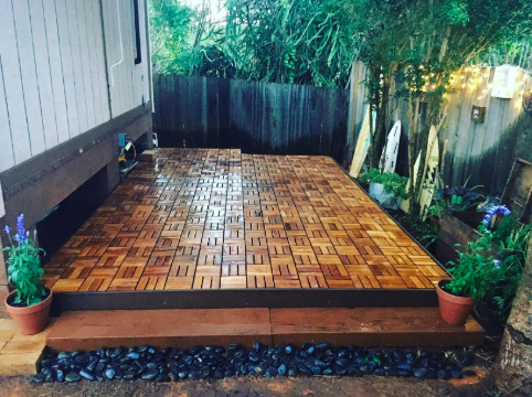A reviewer's image showing a patio with teak tiles neatly covering the surface.