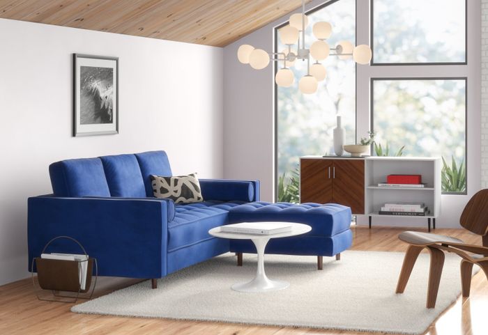 Side view of the blue couch in a living room setting