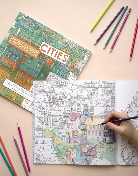 Someone coloring in the Fantastic Cities coloring book.