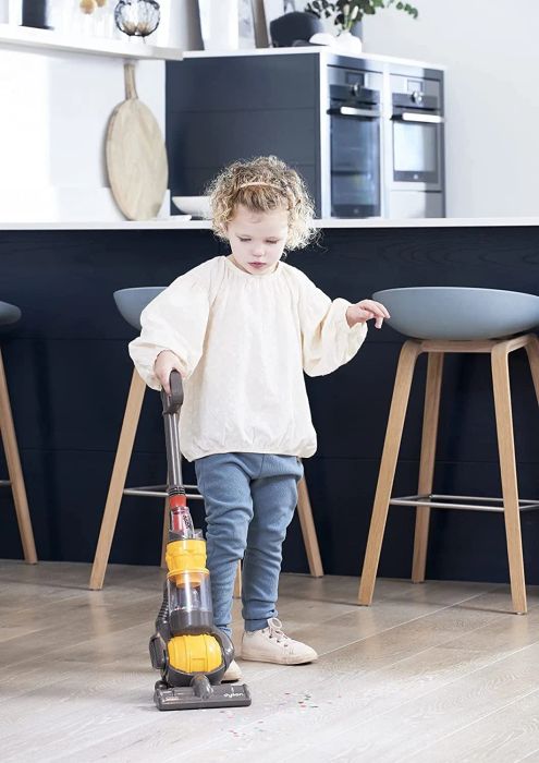 A child playing with a realistic mini Dyson Ball toy