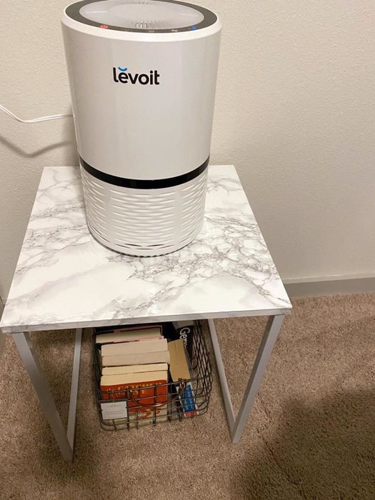 A reviewer’s side table, featuring a chic marble-look top made from contact paper, offering a sophisticated and high-end appearance.
