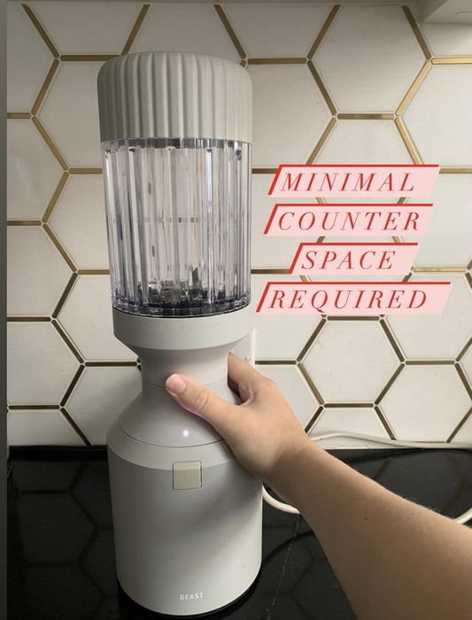 The tall, circular, light grey blender sitting in my kitchen is a prominent feature.