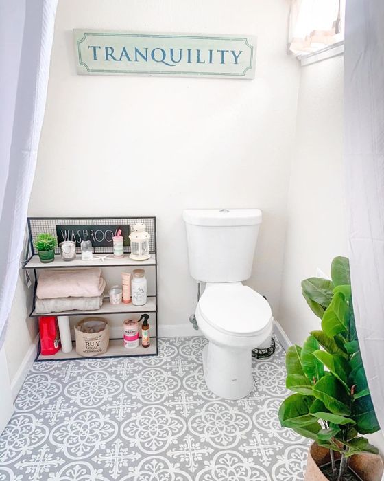 A reviewer's bathroom showcasing grey and white floral pattern tiles.