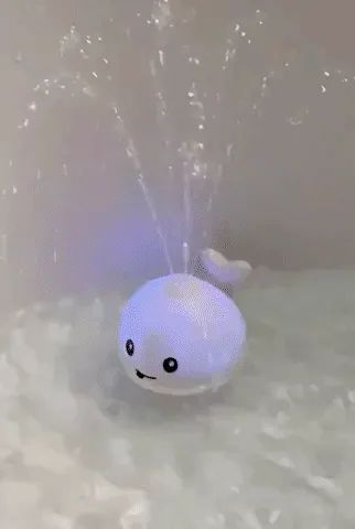 A review GIF showing the whale bath toy in action, lighting up and spraying water.