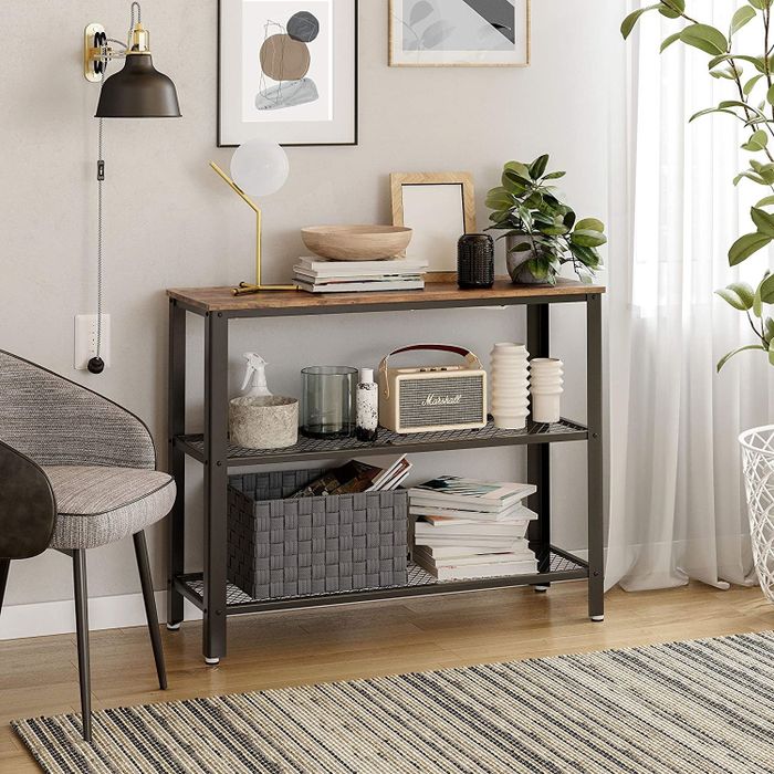 A long rectangular table with a wooden top and two mesh shelves underneath for added storage.