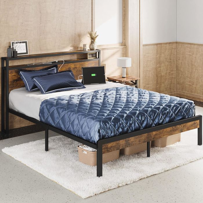 A modern bed featuring patterned bedding and a white rug, creating a stylish and cozy atmosphere.
