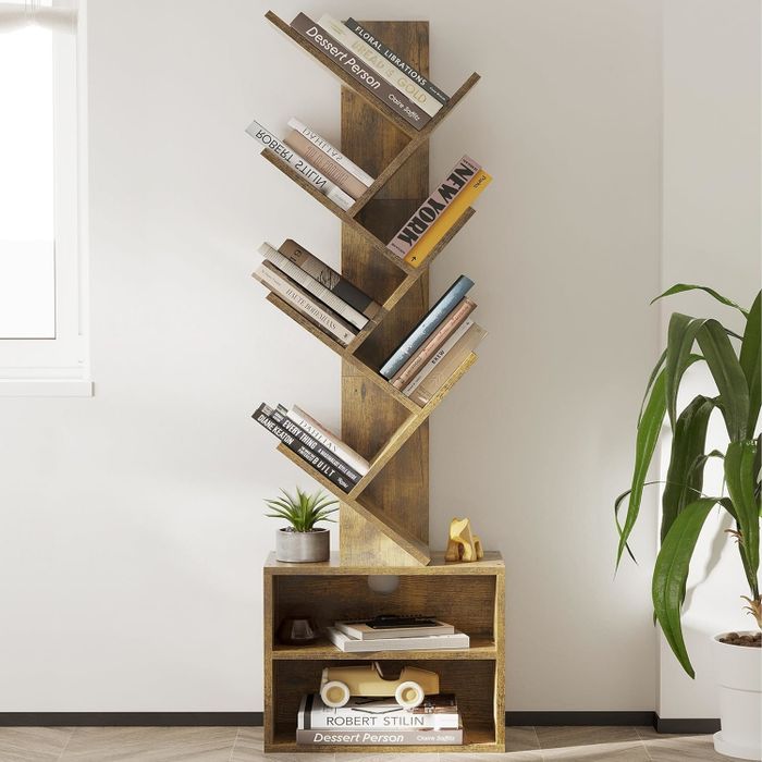 A modern bookshelf with an asymmetrical design, filled with books and a few decorative items.