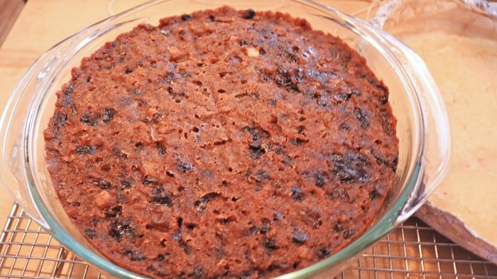 A bowl containing a fruit cake.
