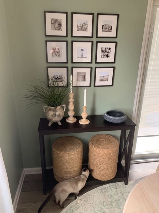 A reviewer's photo showing two natural-colored ottomans